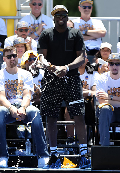 Jun 19, 2015; Oakland, CA, USA; Golden State Warriors forward Draymond Green (23) sprays champagne during the Golden State Warriors 2015 championship celebration at the Henry J. Kaiser Convention Center. Mandatory Credit: Kelley L Cox-USA TODAY Sports